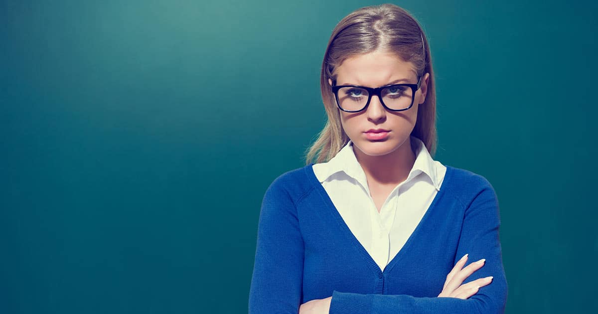 Young woman with arms folded in judgement