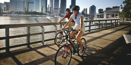 Cycling alongside the Brisbane River.