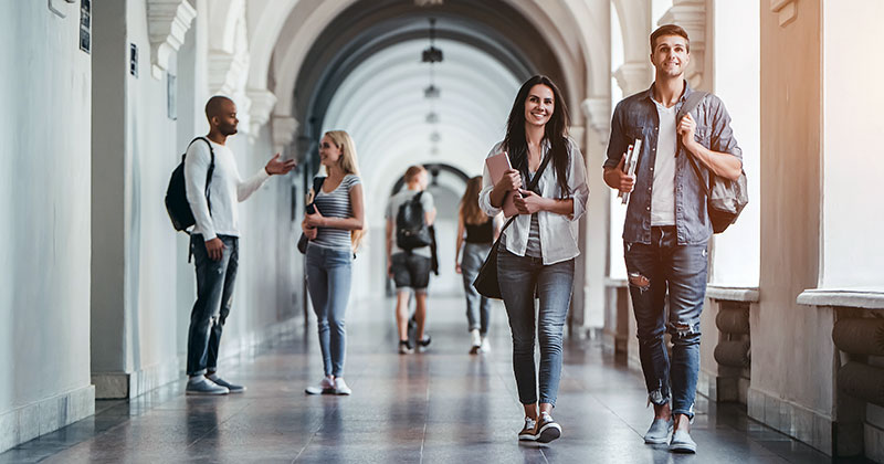 University students walking along corridor